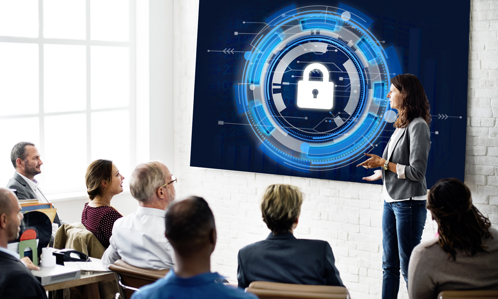  A group of employees are sitting in a room attending a cybersecurity training workshop.